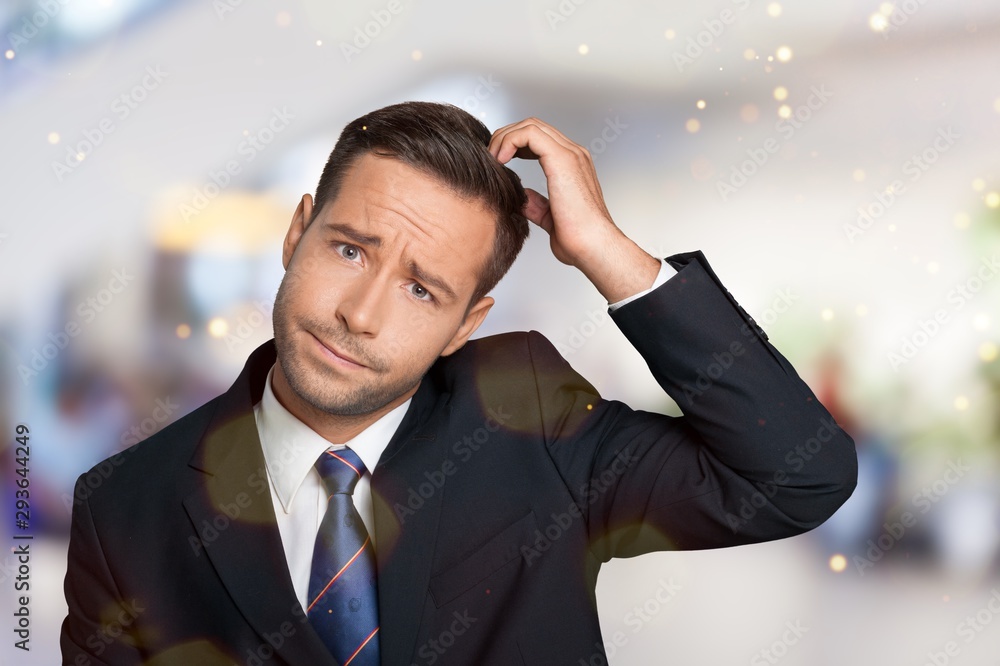 Young businessman scratching his head, hard decision