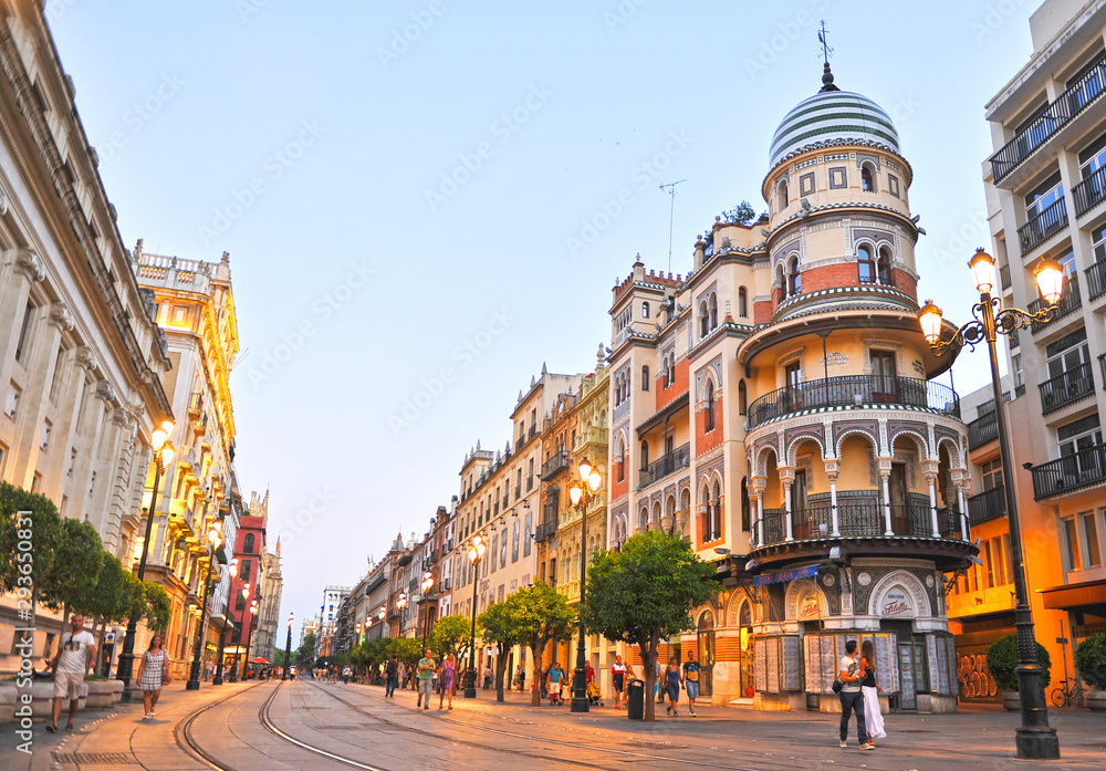 Sunset on Avenue of Constitution (Avenida de la Constitución) in downtown of Seville Andalusia Spain