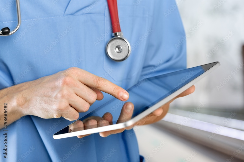 Close-up Doctor at hospital working with tablet pc