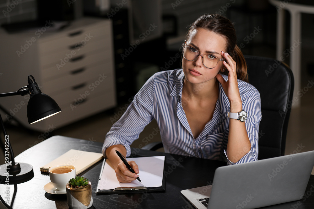 Young businesswoman trying to meet deadline in office