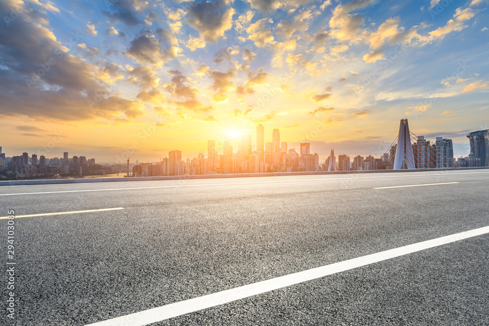 Asphalt highway and modern city financial district skyline in Chongqing at sunset,China.