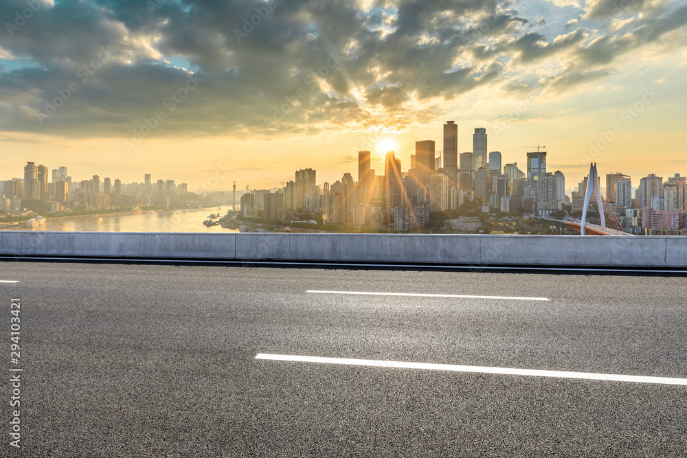 Asphalt highway and modern city financial district skyline in Chongqing at sunset,China.