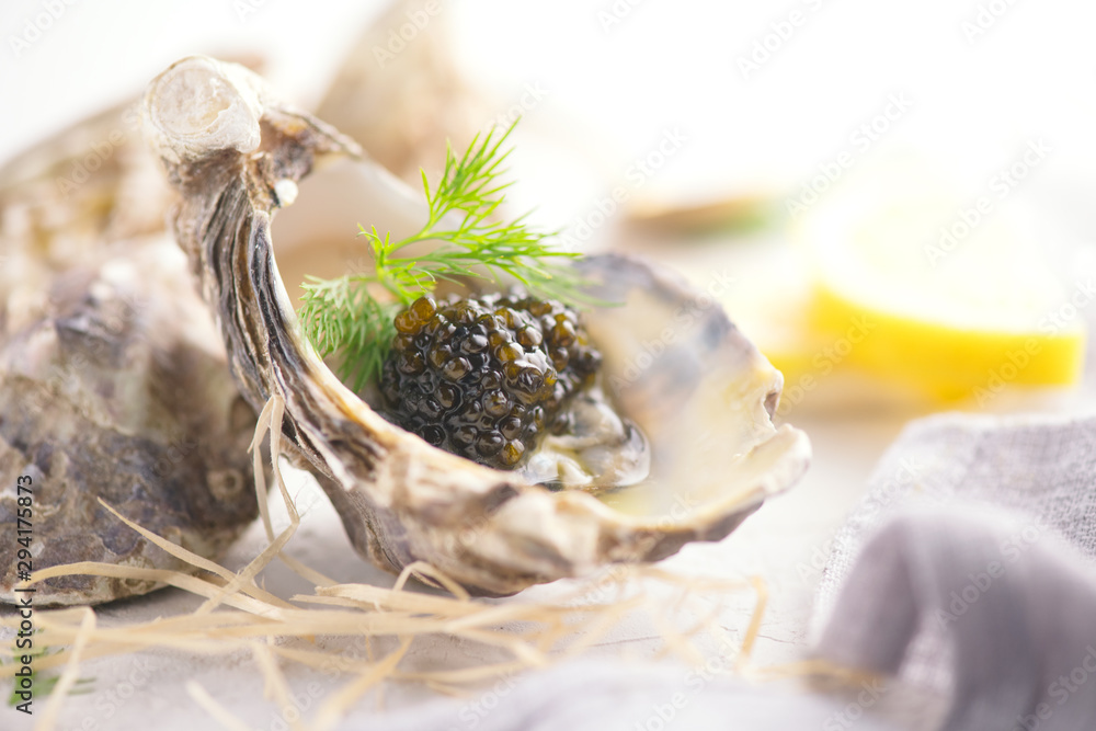 Fresh oysters with black caviar. Opened oysters with black sturgeon caviar and lemon, Gourmet food i