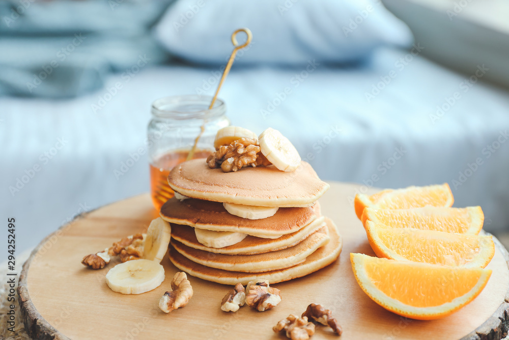 Tray with tasty breakfast in bedroom