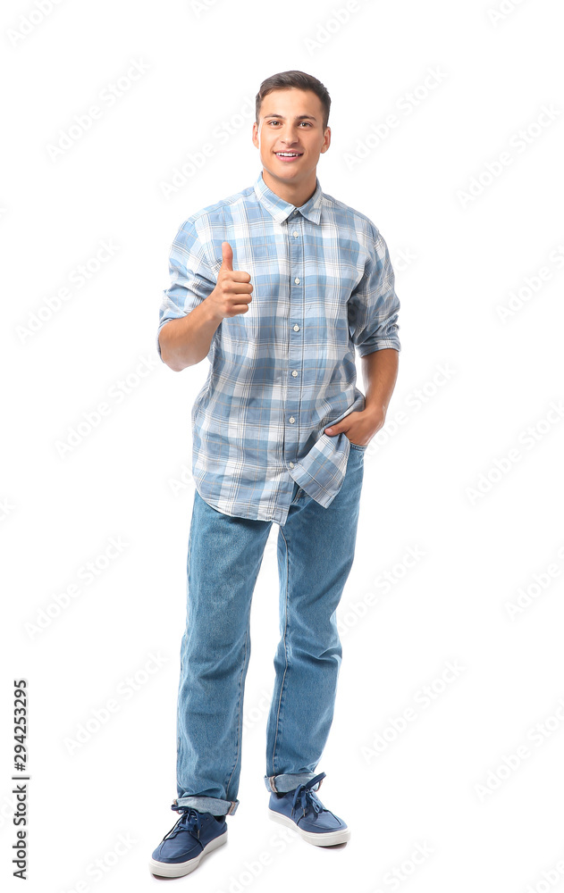 Portrait of handsome young man showing thumb-up on white background