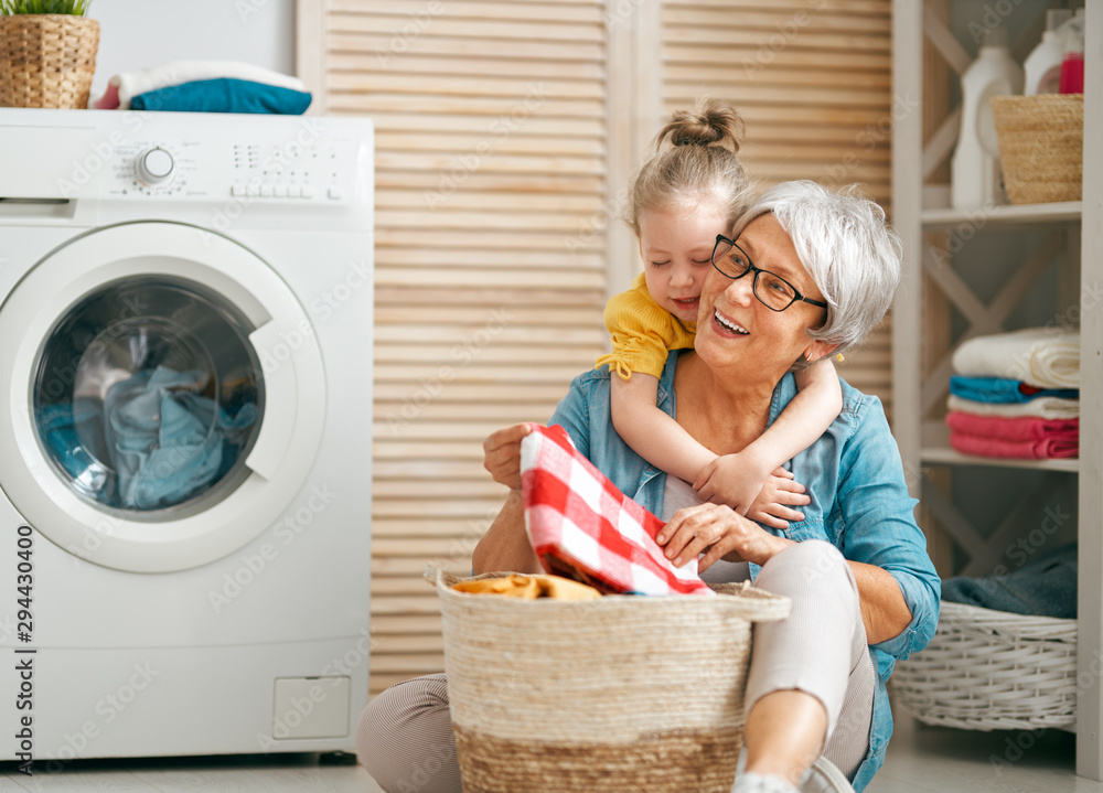 grandma and child are doing laundry