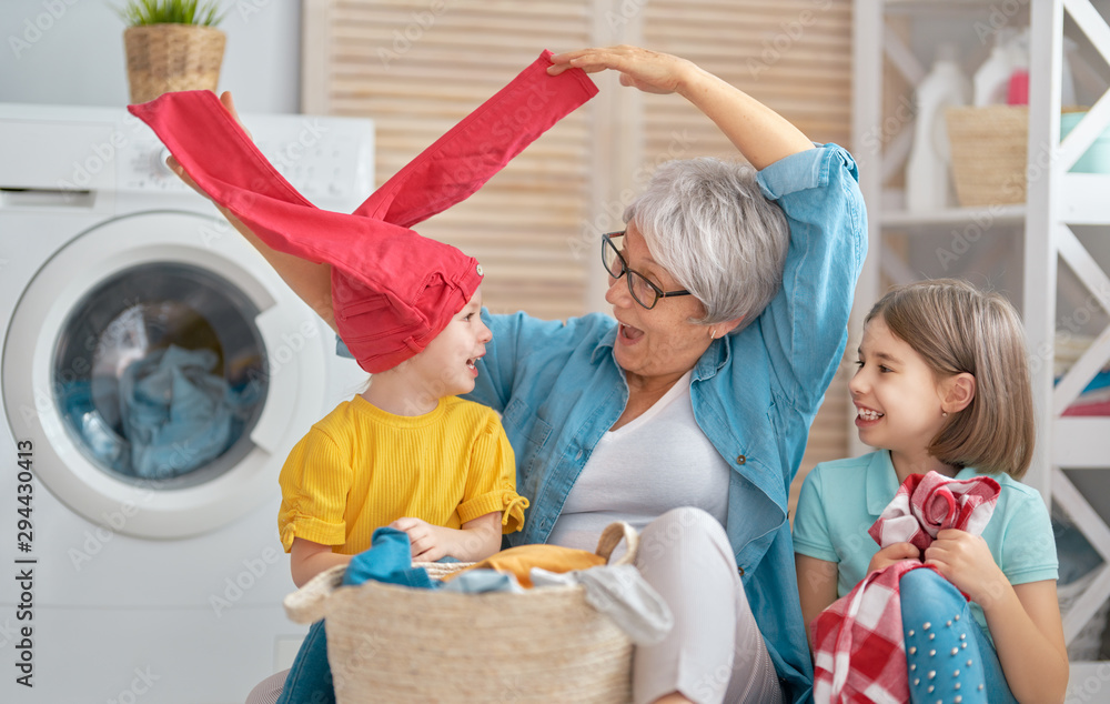 grandma and children are doing laundry