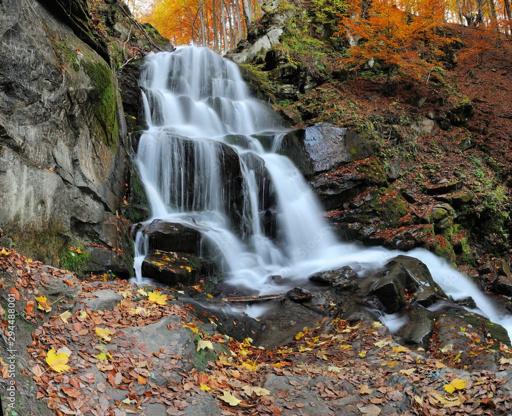 Mountain waterfall in autumn forest