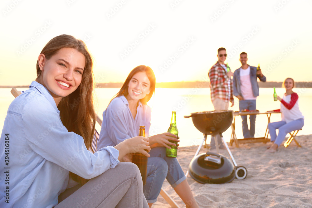 Young women at barbecue party near river