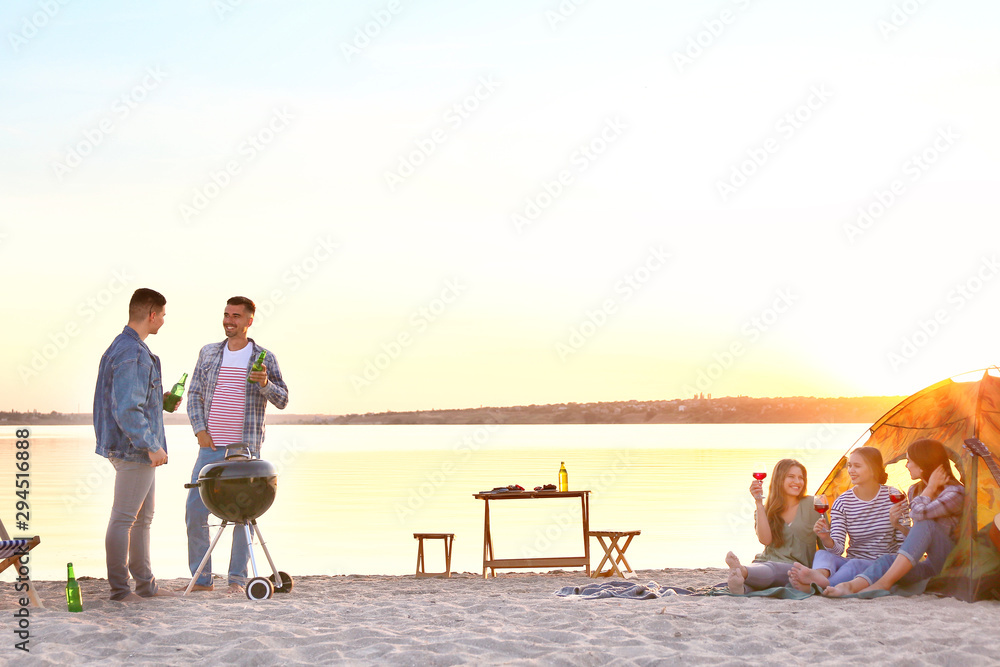 Friends at barbecue party near river