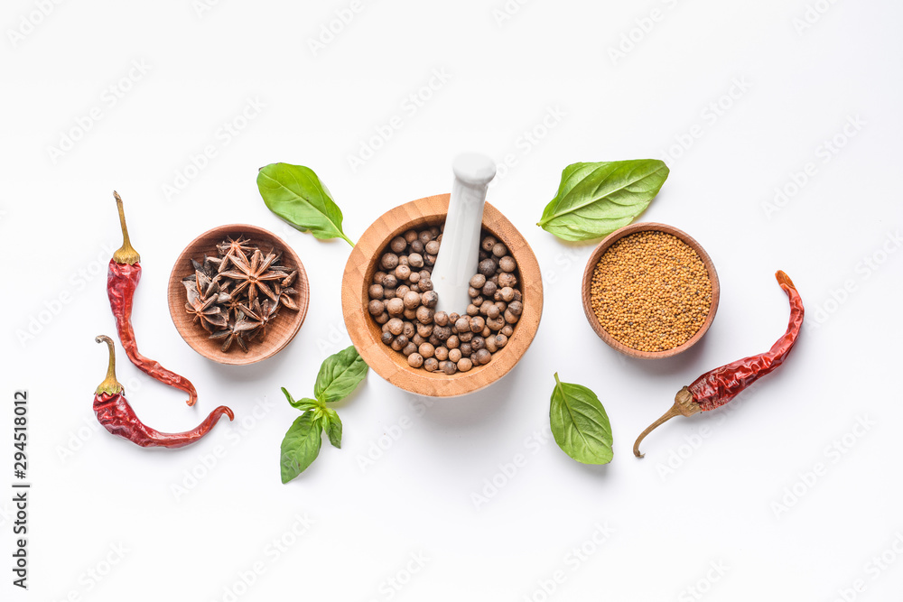 Bowls with different spices on white background