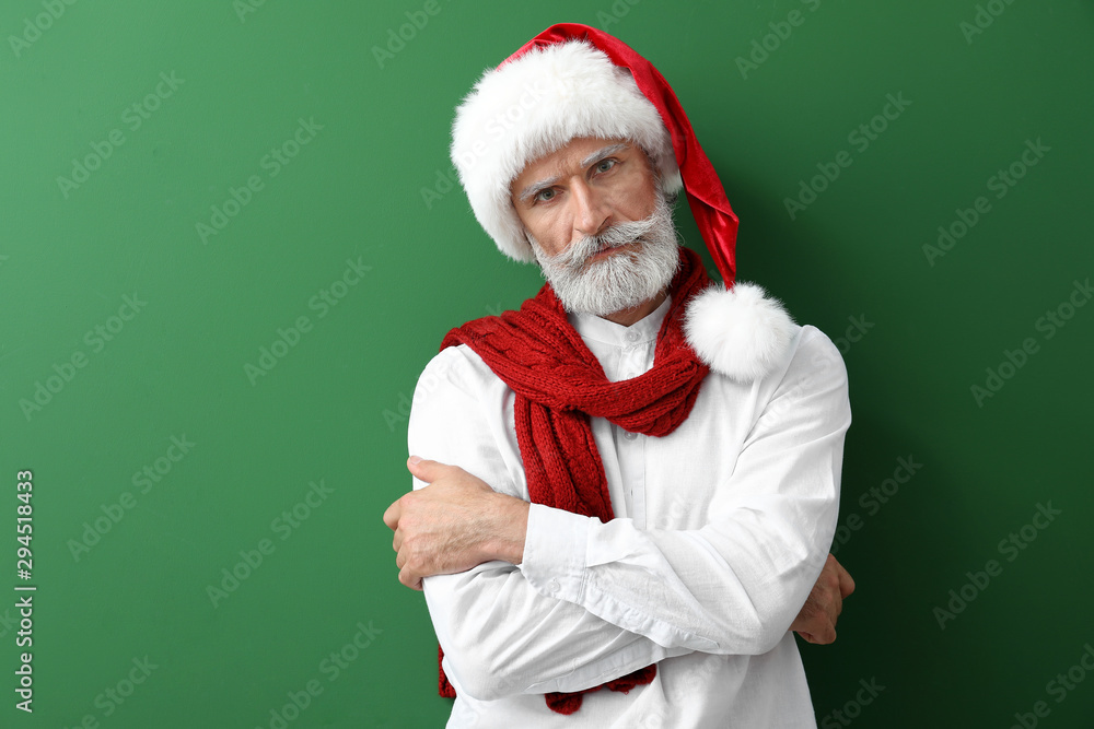 Portrait of stylish Santa Claus on color background