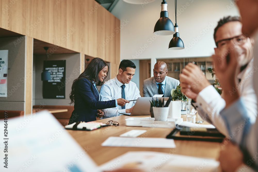 Smiling group of diverse businesspeople working together in an o