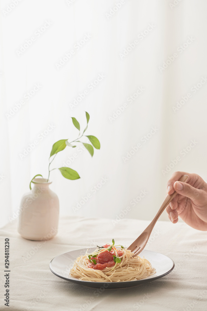 Spaghetti on a fork. Pasta with fresh tomatoes and herbs