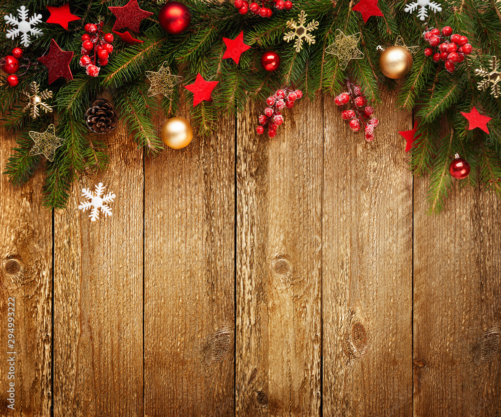 Christmas wooden background with decoration and fir tree. View with copy space.