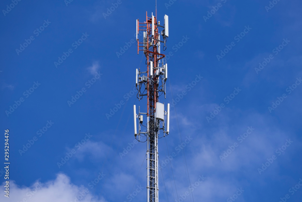 Telecommunication telephone signal transmission tower with beautiful blue sky and cloudy background