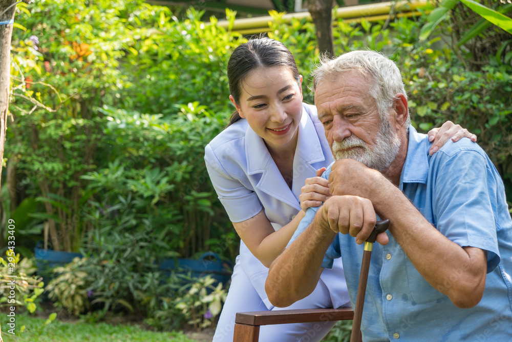 Young nurse take care senior man at home, Senior man happniess and smiling with nurse, Health care c