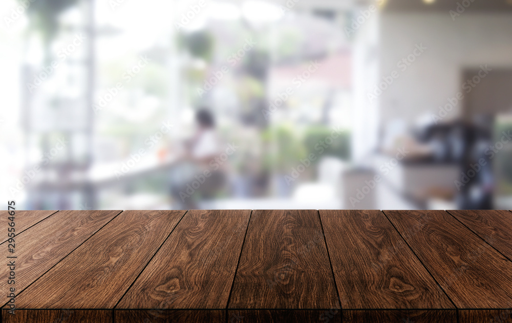 Wood table in blurry background of modern restaurant room or coffee shop with empty copy space on th