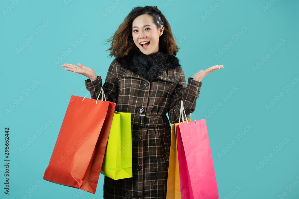 Asian woman are shopping in the winter she is using a credit card and enjoys shopping.