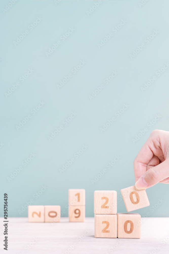 Abstract 2020 & 2019 New year countdown design concept - woman holding wood blocks cubes on wooden t