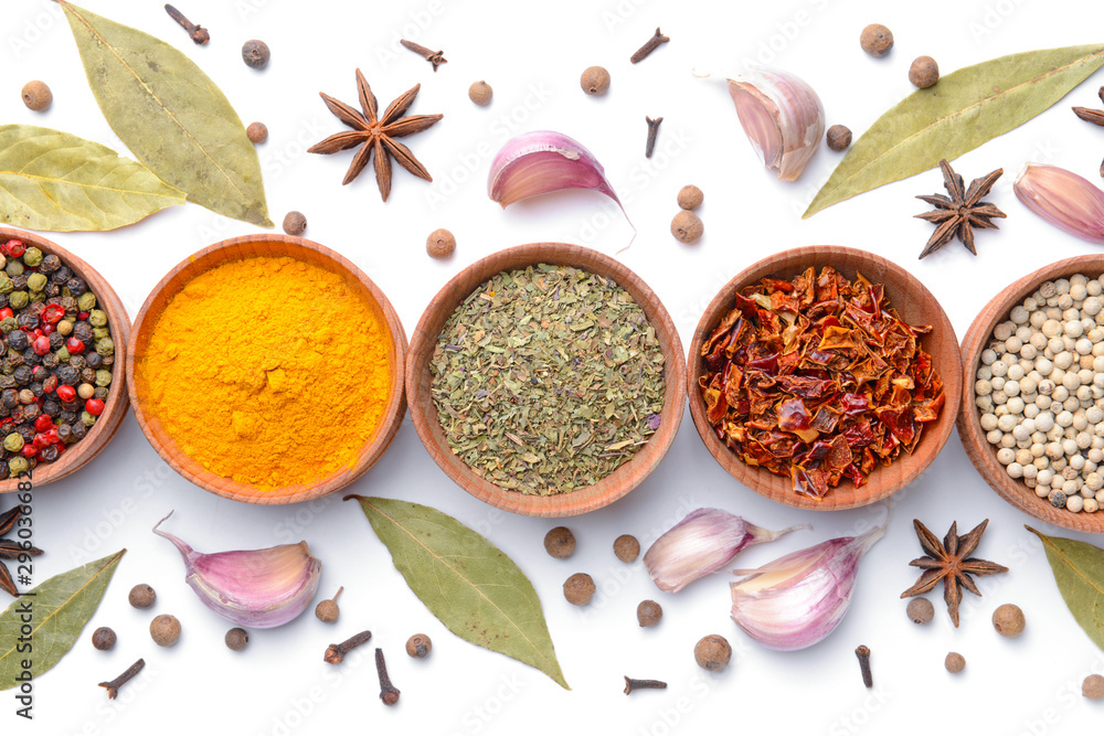 Bowls with different spices on white background