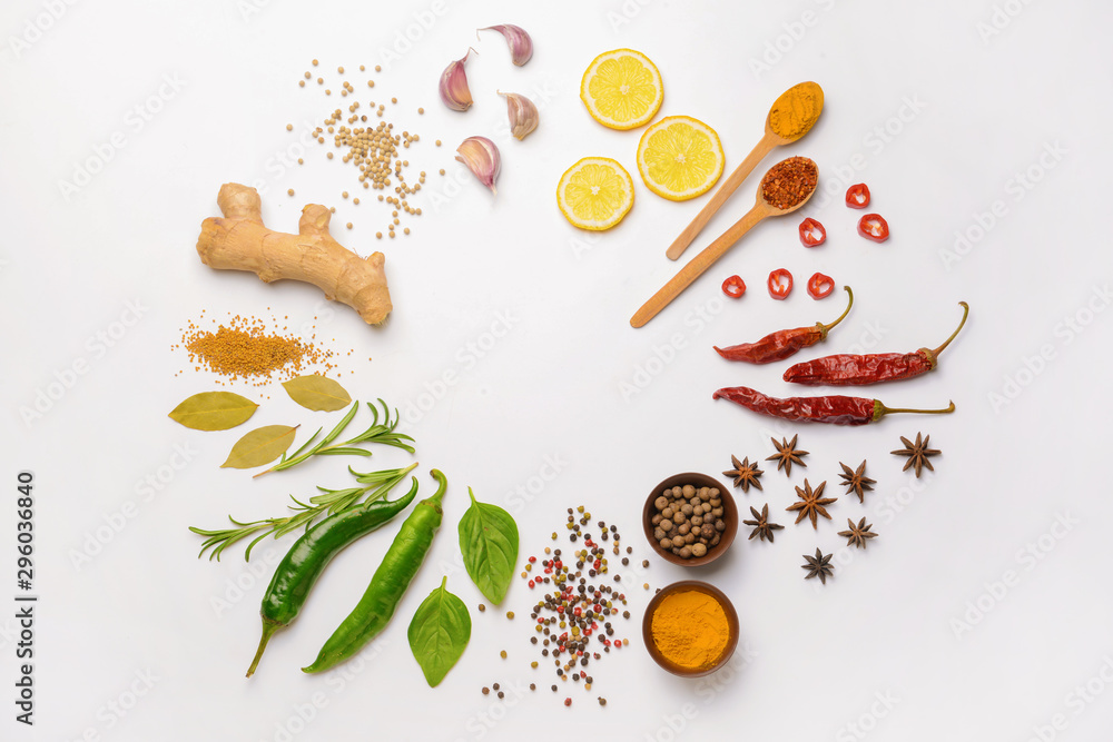 Frame made of different spices on white background