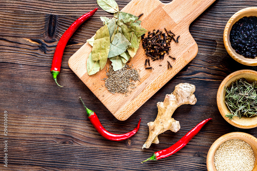 Spices, chili and herbs on wooden kitchen table background top view mock up