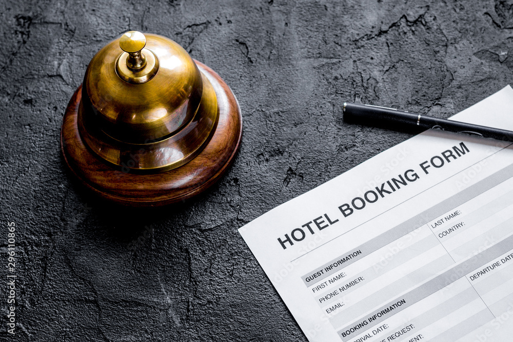 booking hotel room application form and ring dark desk background