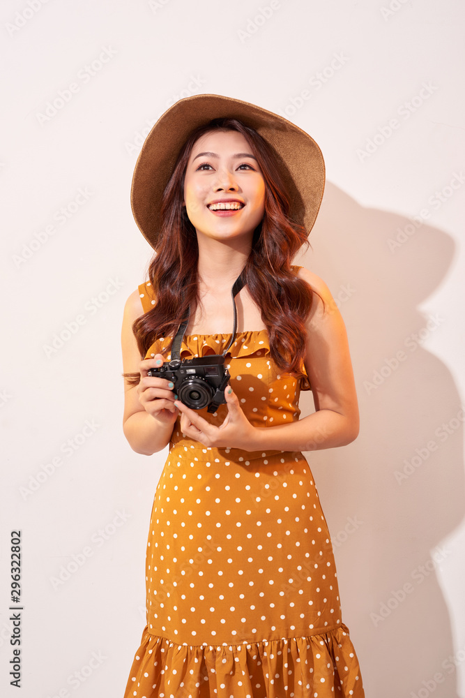 Portrait of cheerful smiling young woman taking photo with inspiration and wearing summer dress. Gir