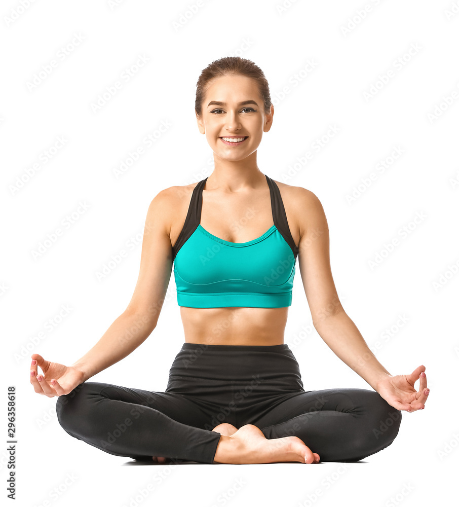 Beautiful young woman practicing yoga on white background