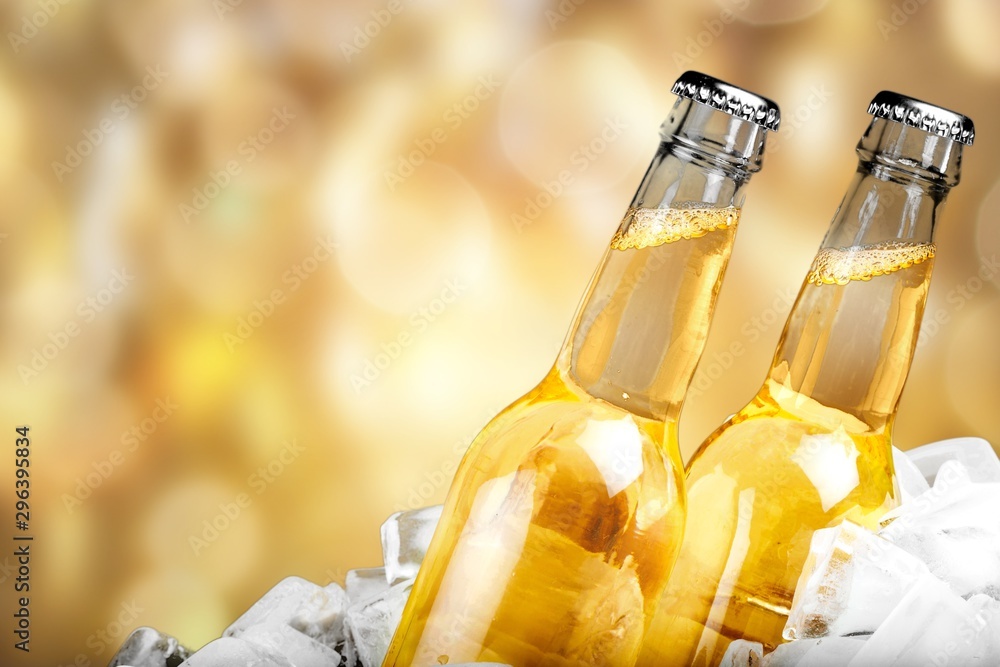 Bottles of cold and fresh beer with ice isolated on white