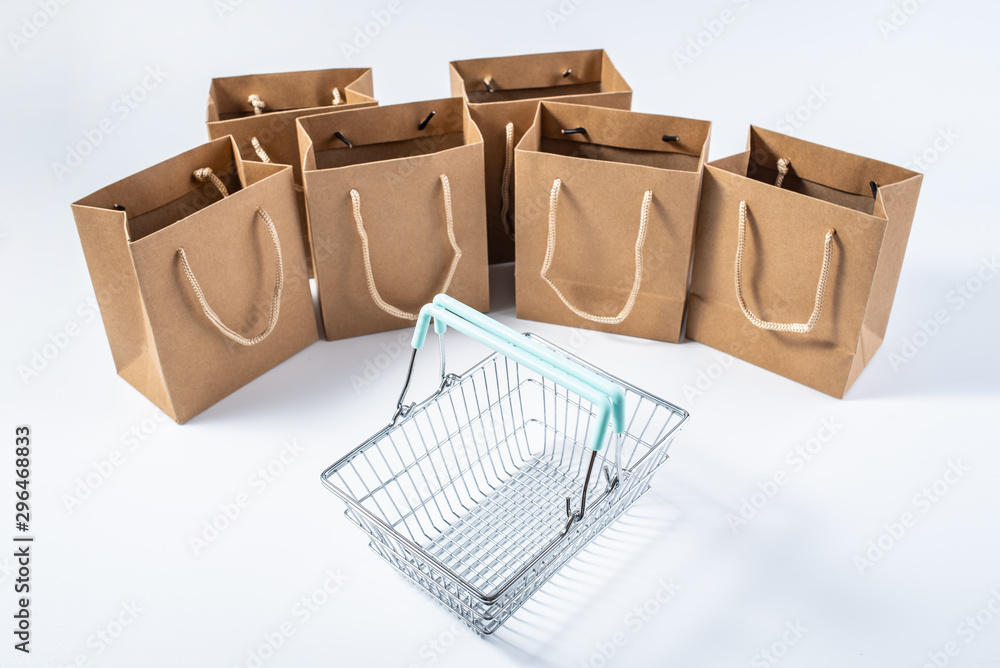 Shopping basket and kraft paper shopping bag consumption online shopping concept illustration on whi