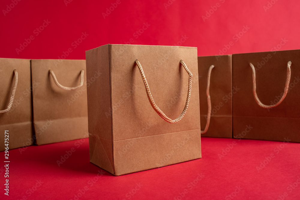 Kraft shopping bag consumption online shopping concept illustration on red background