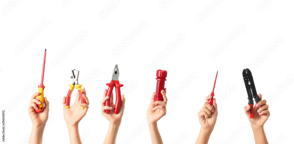 Female hands with electricians tools on white background