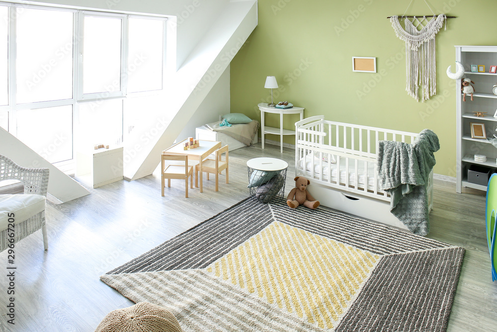 Interior of stylish childrens room with baby bed