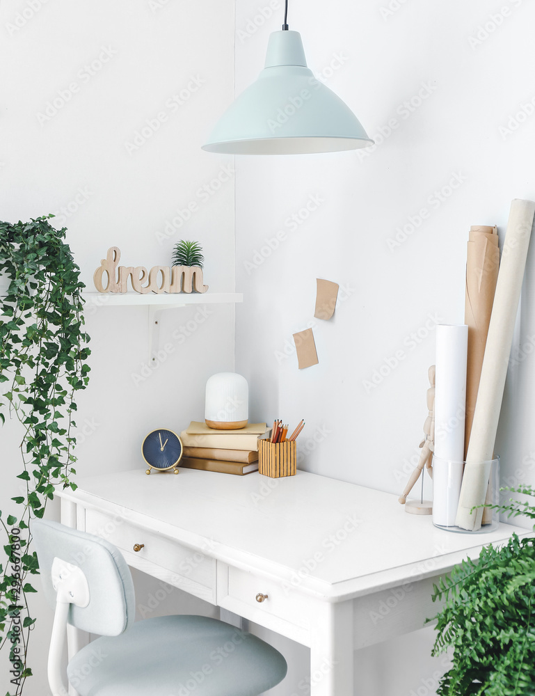 Modern stylish workplace with houseplants