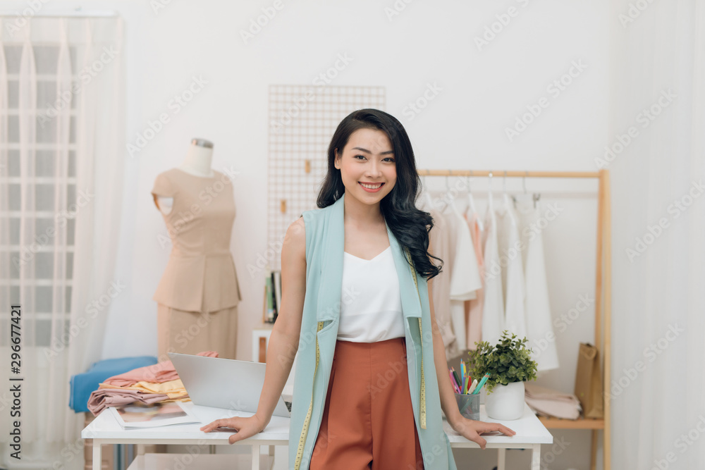 Portrait of young business woman in the store/ fashion designer in her workshop