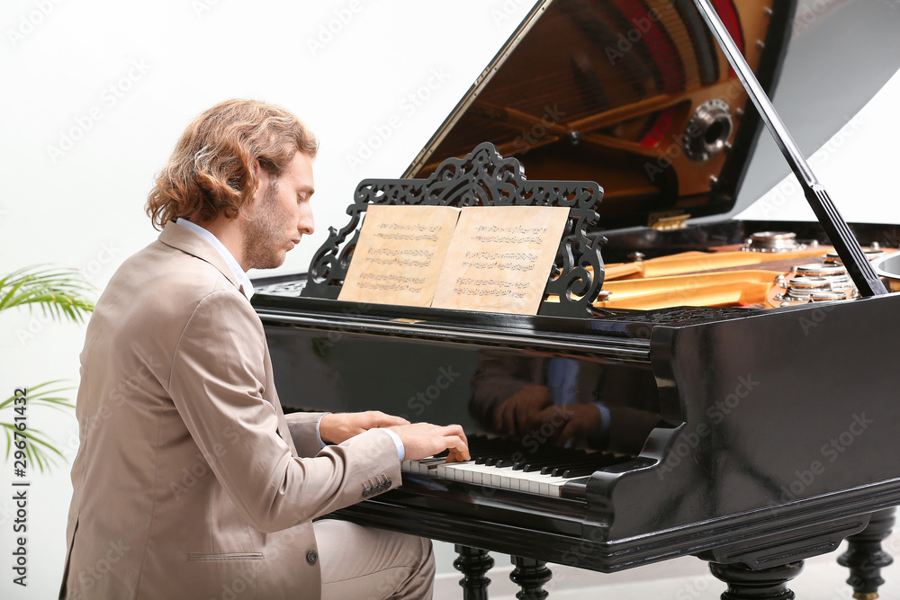 Man playing grand piano at home