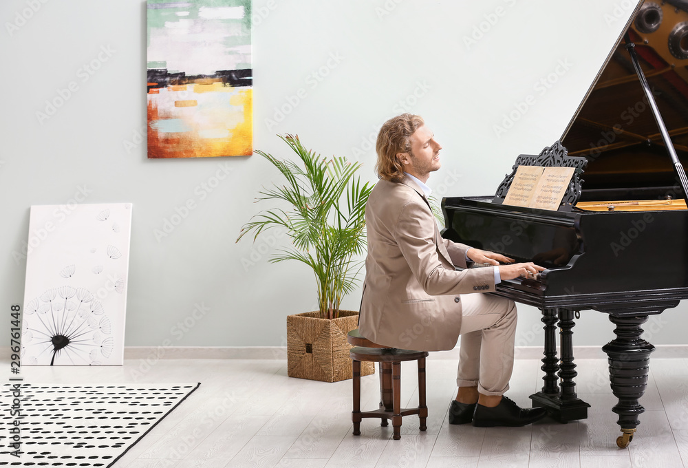 Man playing grand piano at home