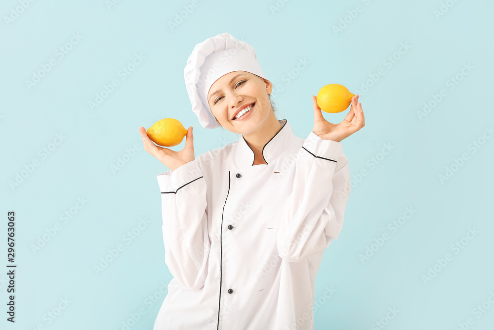 Beautiful female chef with lemons on light background