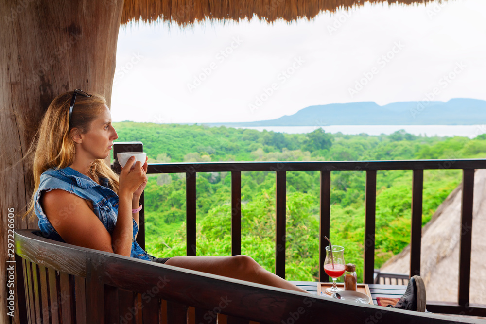 Happy family travel, explore rainforest near Pemuteran. Young woman drink morning coffee and relax o