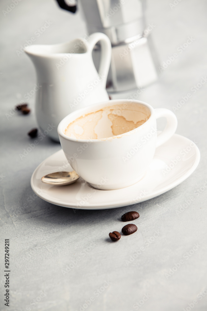 Empty coffee cup after drink on concrete background