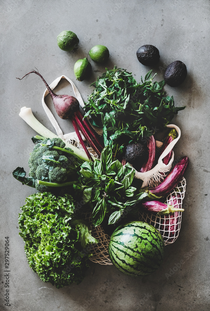 Healthy grocery goods. Flat-lay of net bag full of vegetables, fruits, greens from local farmers mar