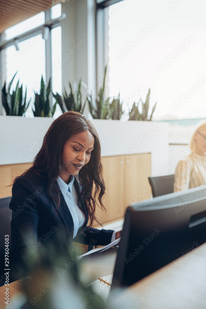 Focused young African American businesswoman working at her offi