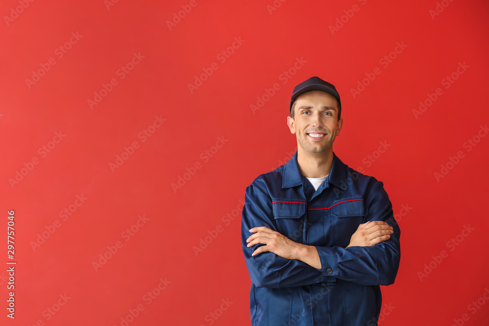 Male car mechanic on color background