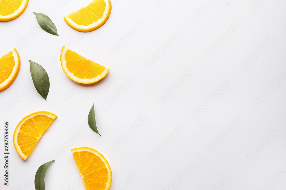 Fresh orange slices with leaves on white background