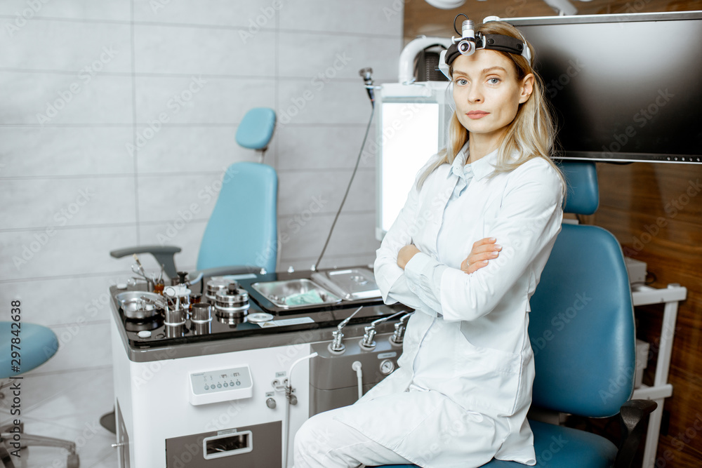 Portrait of a confident female otolaryngologist standing at the ENT office