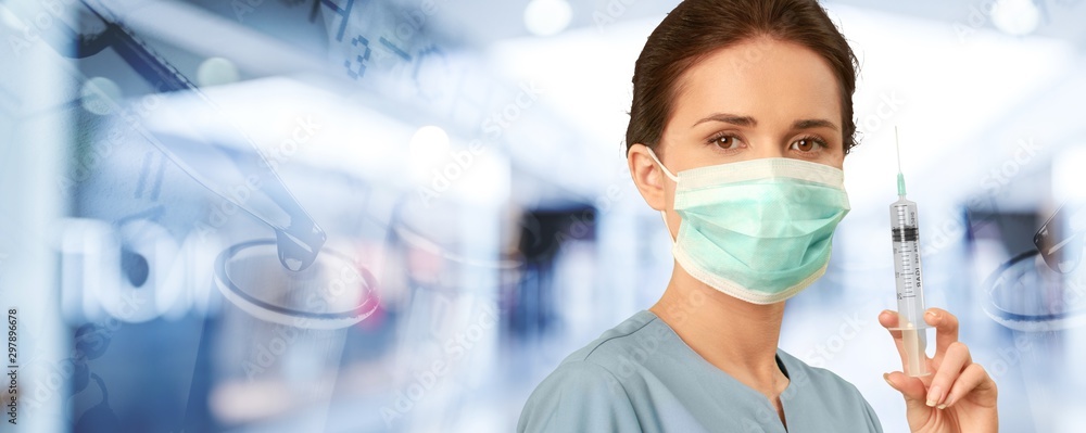 Young female scientist standing  on background