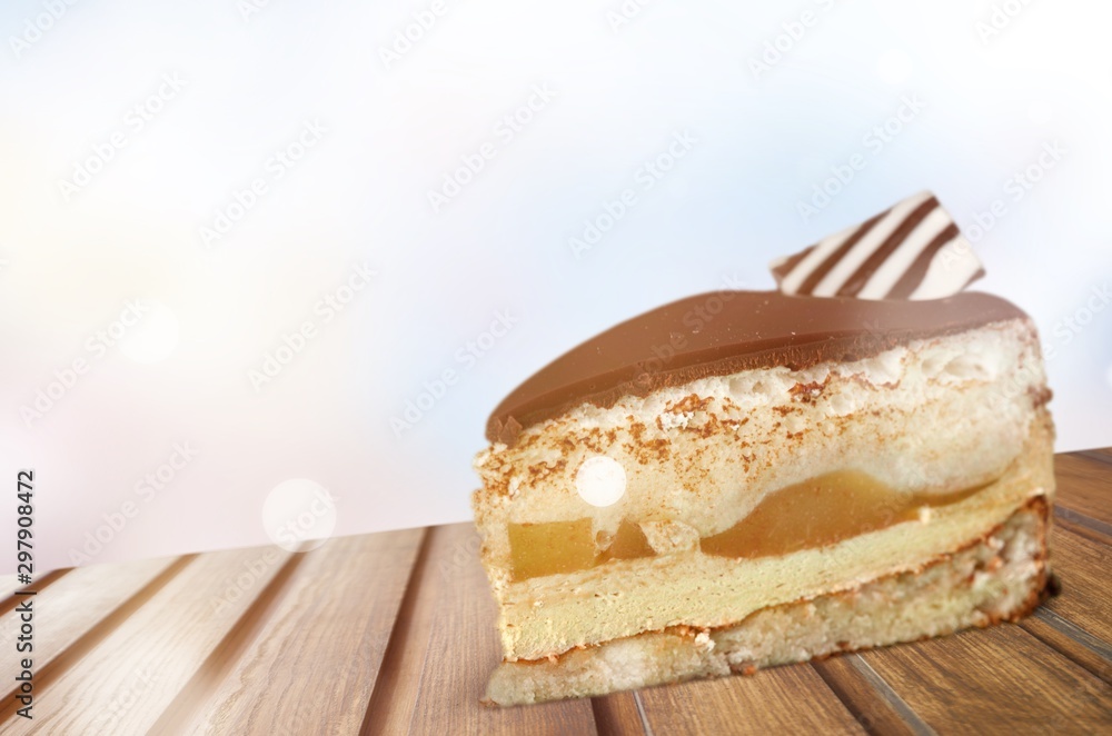 Piece of cake with chocolate creame and fork isolated on white