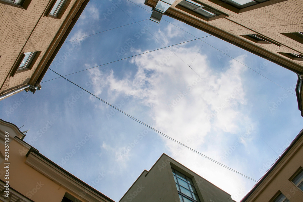 View of the blue sky from the yard-well